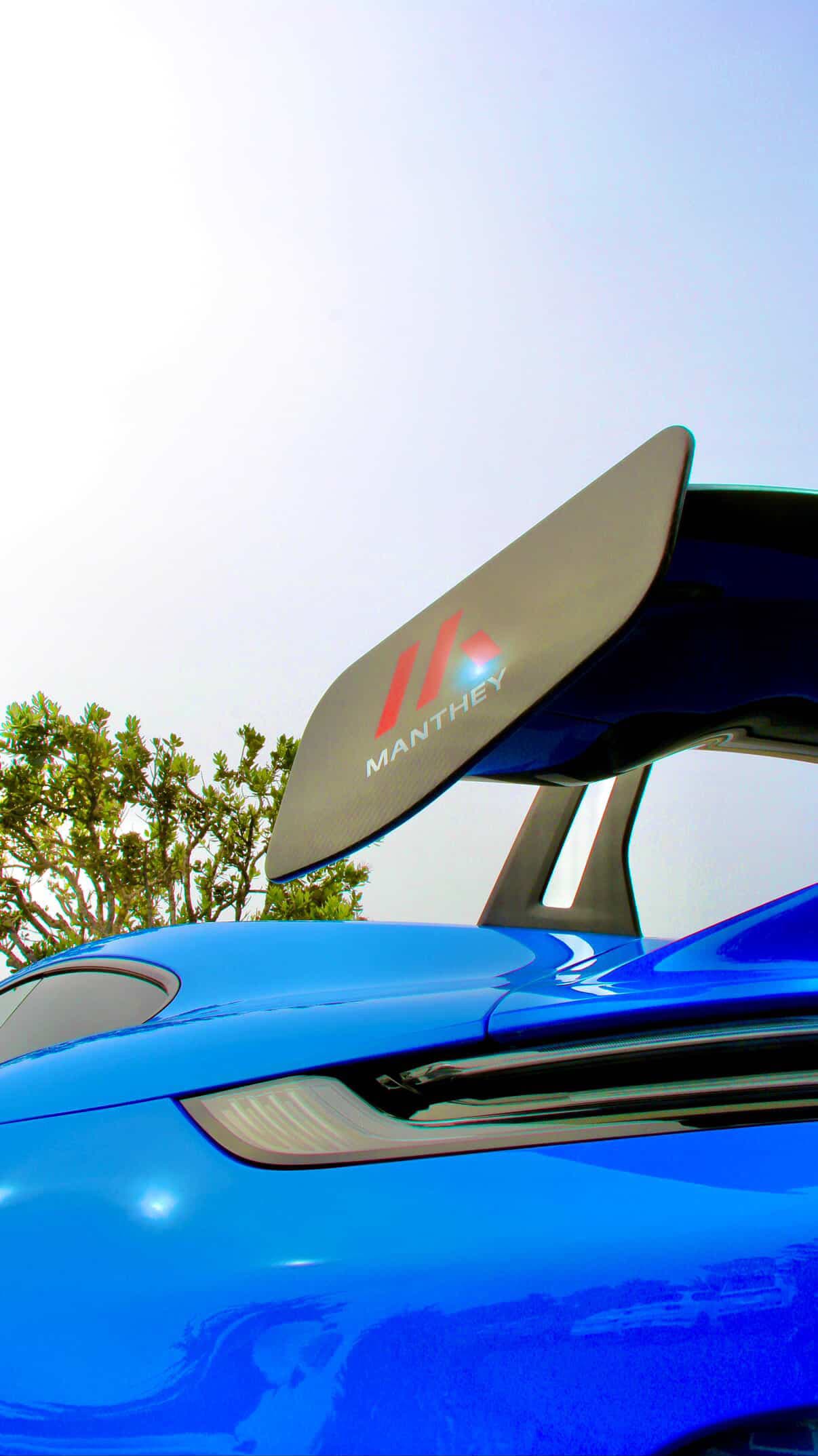 Rear wing detail of a Porsche 911 GT3 with a Manthey Racing badge